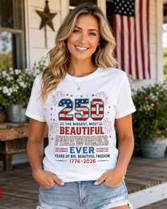 Woman wearing a white t-shirt with 4th of July design in front of an American flag.