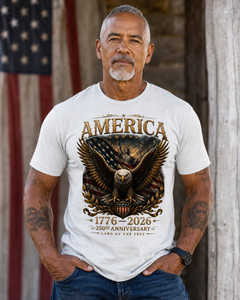 Man wearing a white t-shirt with an eagle and American flag design, standing in front of an American flag.