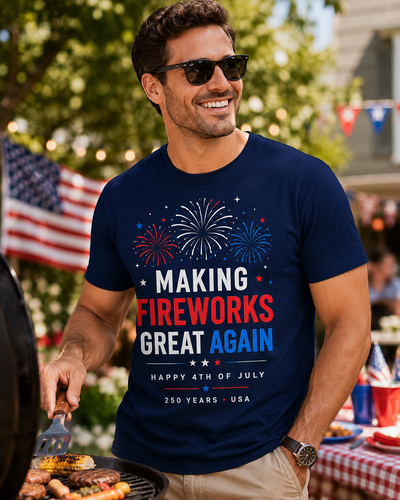 Man wearing a navy blue t-shirt with 4th of July-themed text and graphics, standing outdoors with American flags in the background.