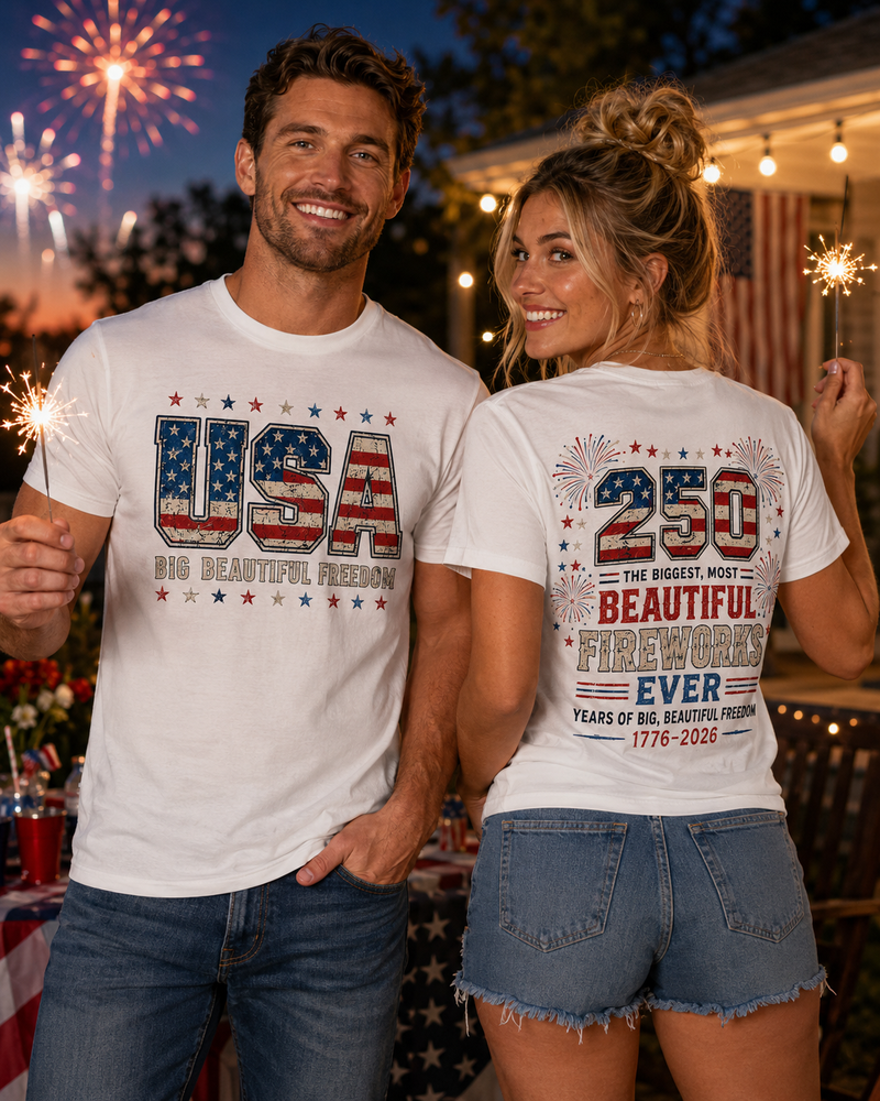 Man and woman wearing matching t-shirts with USA and fireworks designs, celebrating a 250th anniversary event.